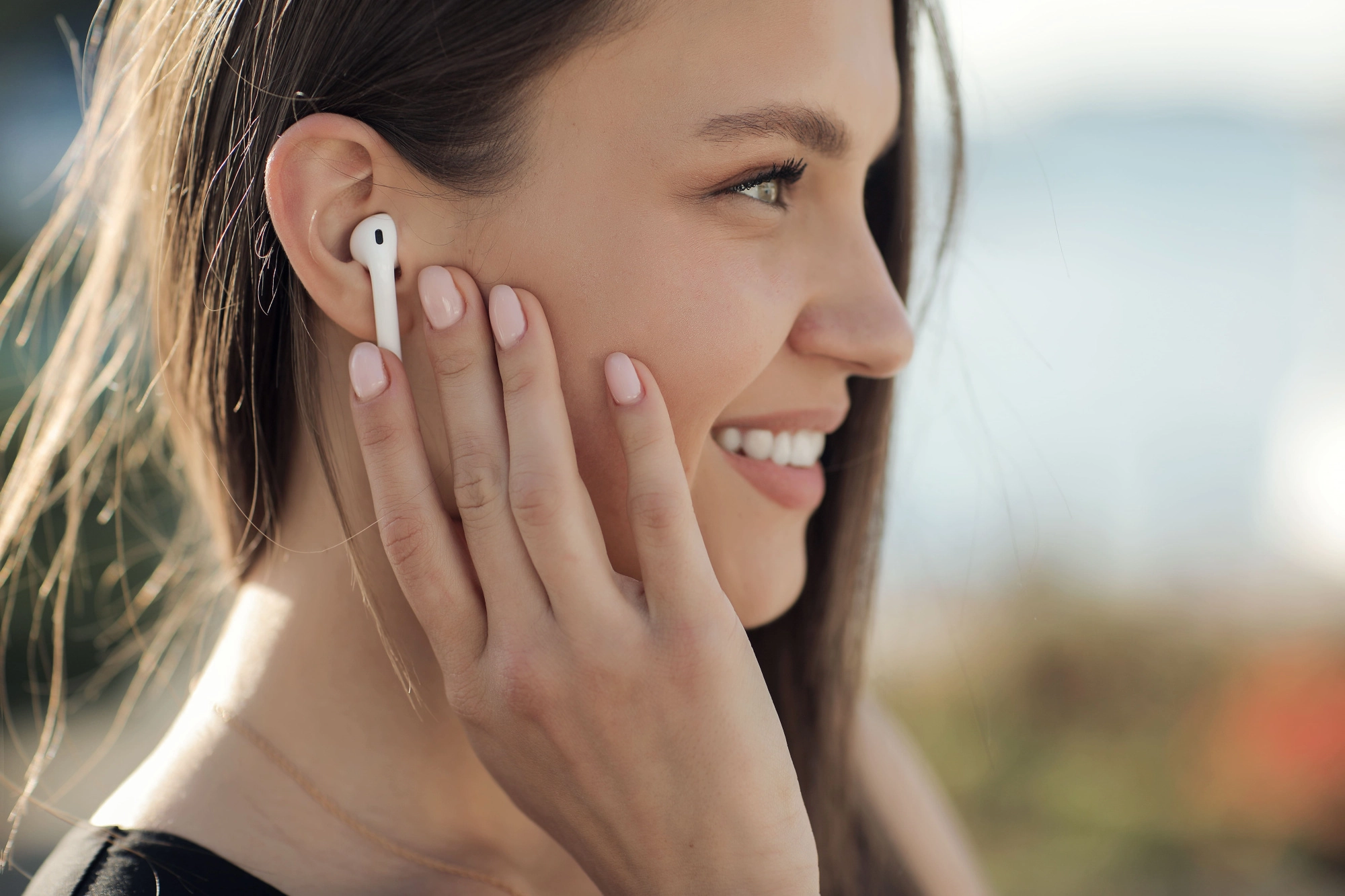 smiling-young-woman-with-headphones-outdoor.jpg
